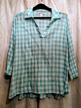 3 quarter sleeve, pullover blouse with split cuffs.